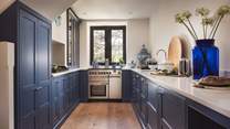 We have fallen in love with the spacious bespoke kitchen in Farrow & Ball Pitch Blue