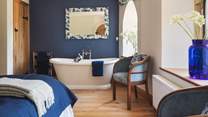 The bedroom has triple aspect windows, gorgeous freestanding roll top bath for two and a super king bed