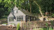 This wonderful wooden cottage tucked amongst the trees is the ultimate romantic country bolthole