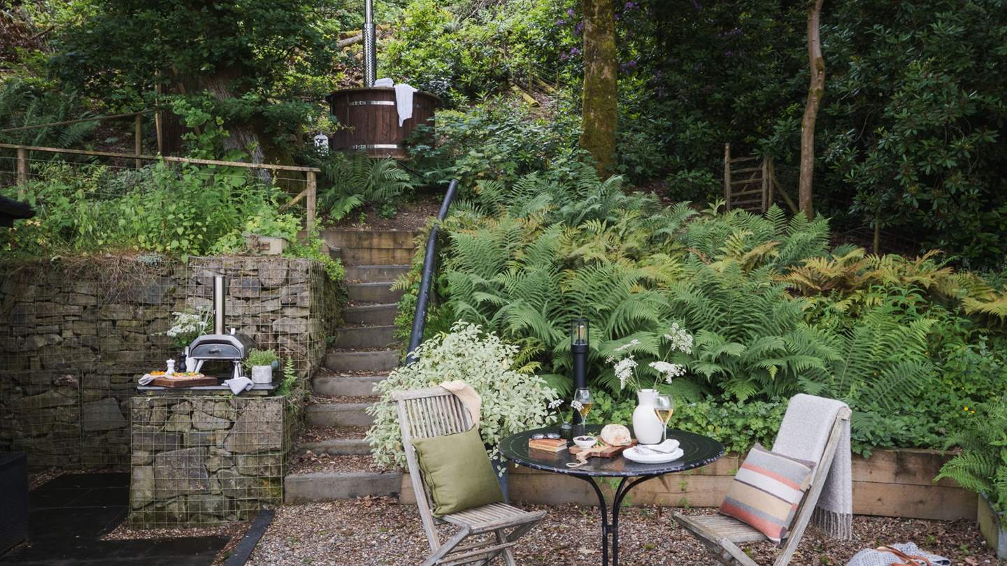 Set on two levels, the lower area is home to a table and chairs for alfresco dining
