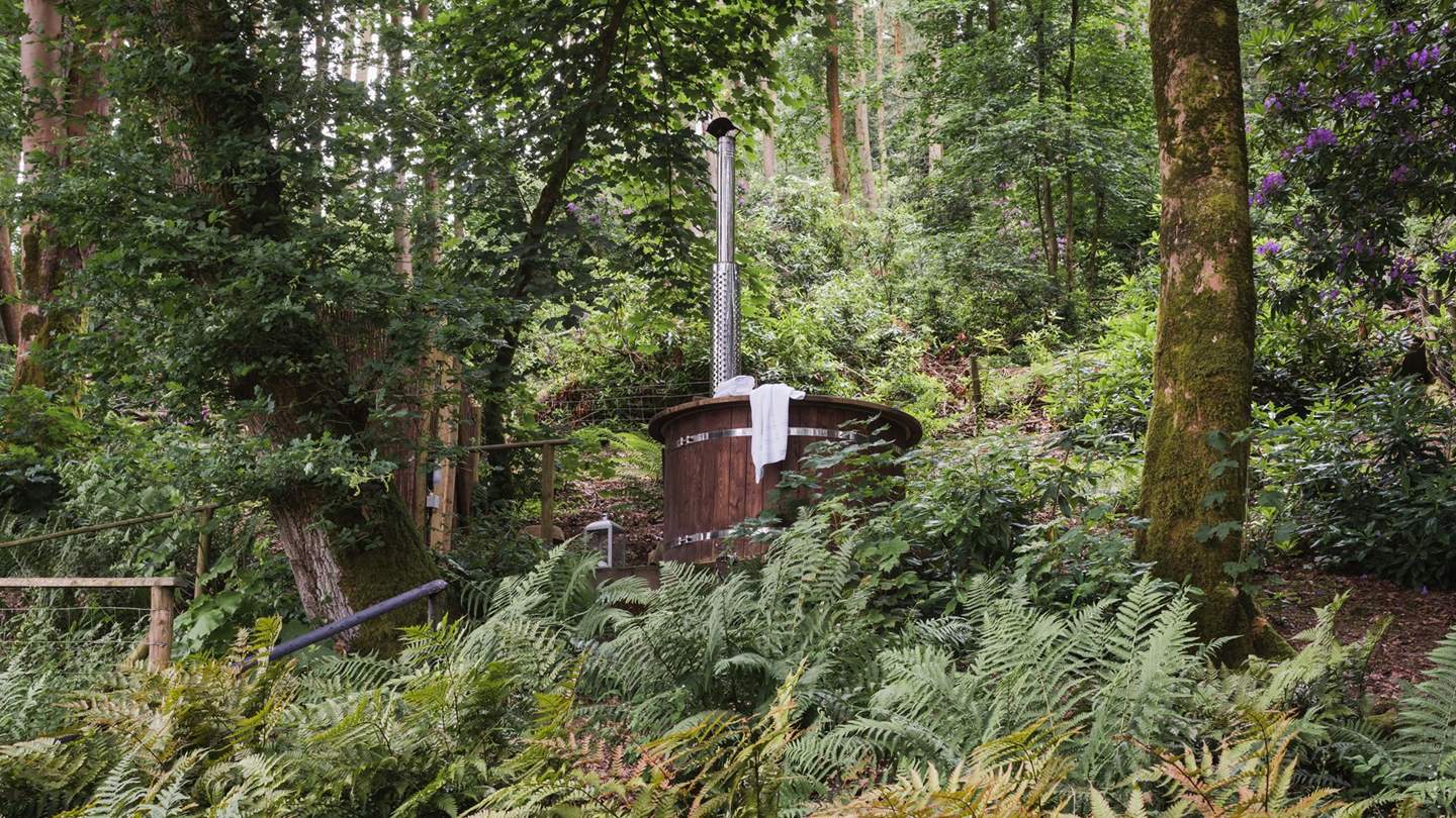 On the upper level, tucked amongst the trees, is the gorgeous wood-fired hot tub where you can relax with just the sounds of the woods accompanying you