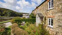 A stunning, traditional two-hundred-year-old Cornish stone cottage directly on the water