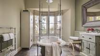 The main bathroom with incredible free standing bath and overhead rainfall shower