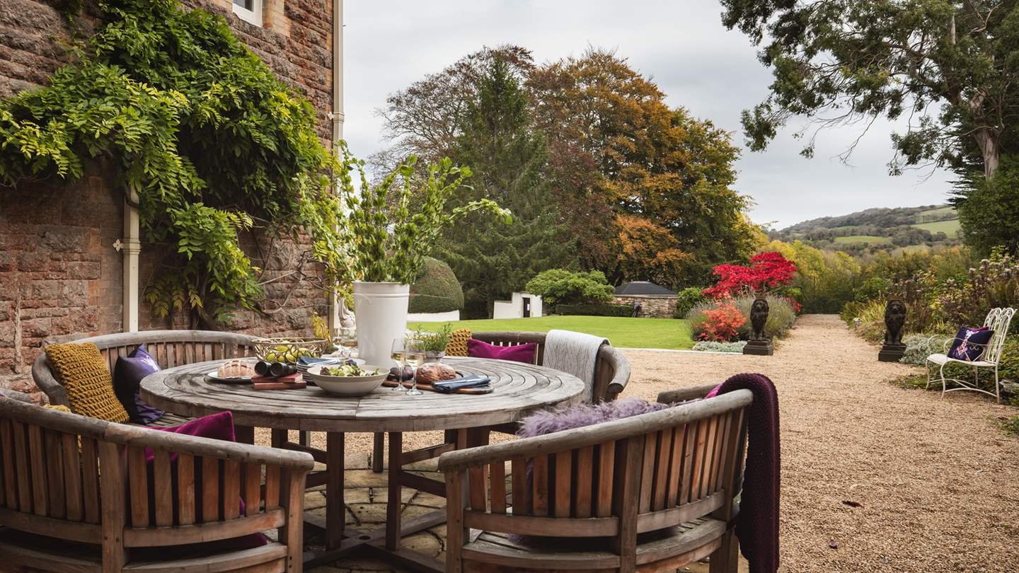 There are plenty of tables and chairs in the garden as well as a large charcoal barbeque