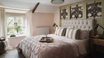 The master bedroom on the first floor lies to the front and overlooks the cottage garden and rolling fields and countryside beyond