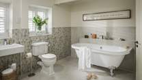 The family bathroom has a fabulous roll top bath for long soaks, plus a separate shower and double sink