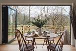 The Ercol quaker-style wooden dining table and chairs is situated to make the most of the views