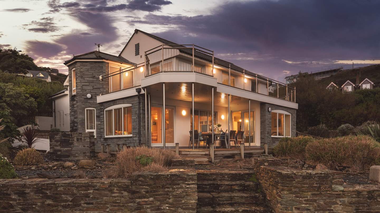 Water's Edge becomes a blissful beacon as the sun begins to set; the ultimate luxurious beach home