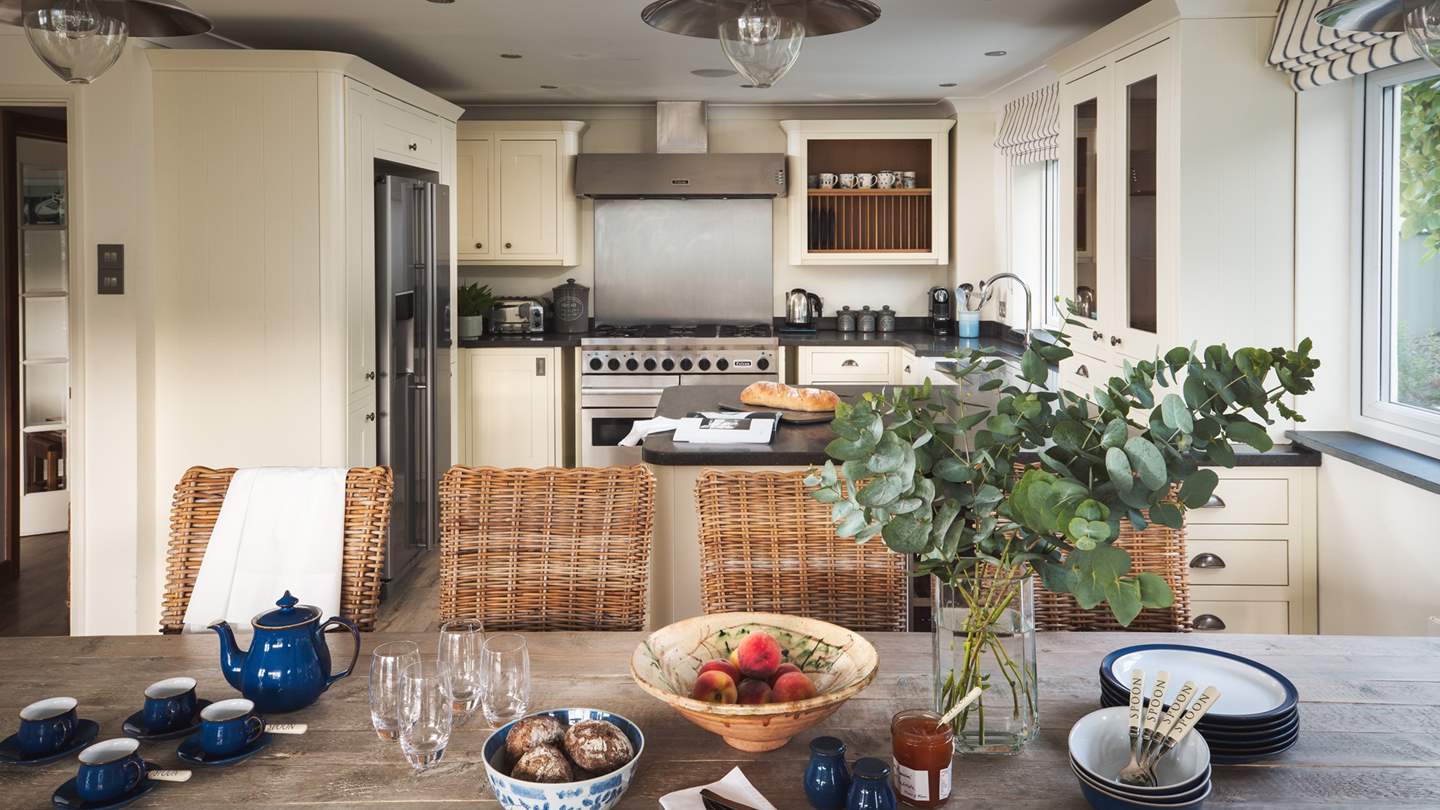 In front of the kitchen lies the large dining table that comfortably seats ten for breakfasts, lunch or dinner