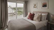 The third bedroom has a cosy double bed, with sliding doors leading to the deck