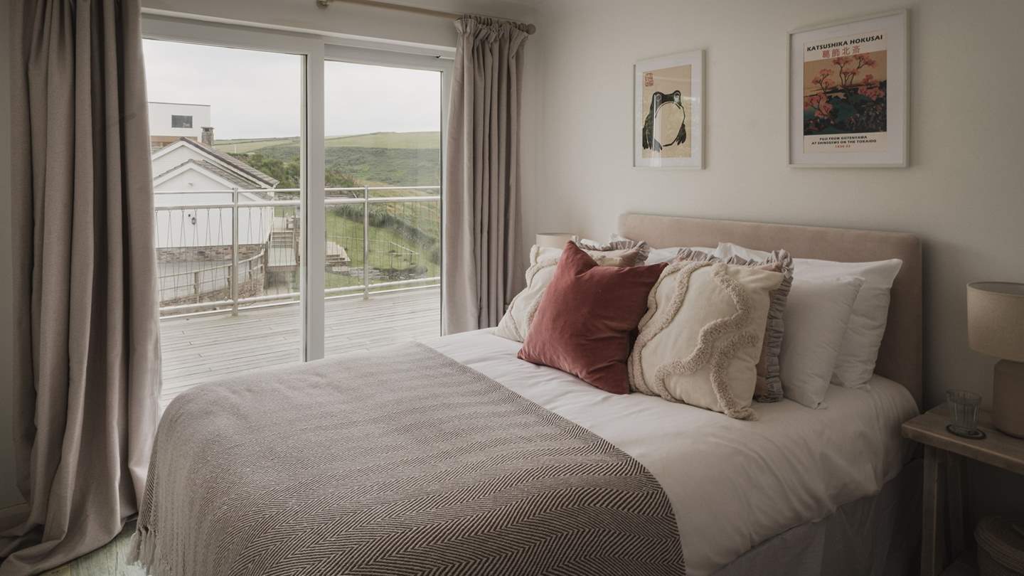 The third bedroom has a cosy double bed, with sliding doors leading to the deck