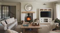 A cosy setting to reside, the living room promises a wood burning stove 