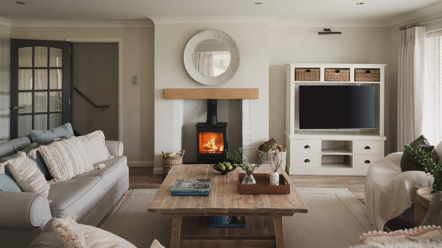 A cosy setting to reside, the living room promises a wood burning stove 