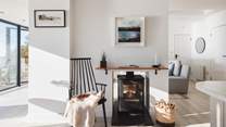 The cosy wood burner, accessible from both the sitting and dining areas, offer cosy heat during cooler months