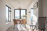 In front of the kitchen is the gorgeous dining area with dual-aspect windows, meaning there's glorious sea views wherever you're sat