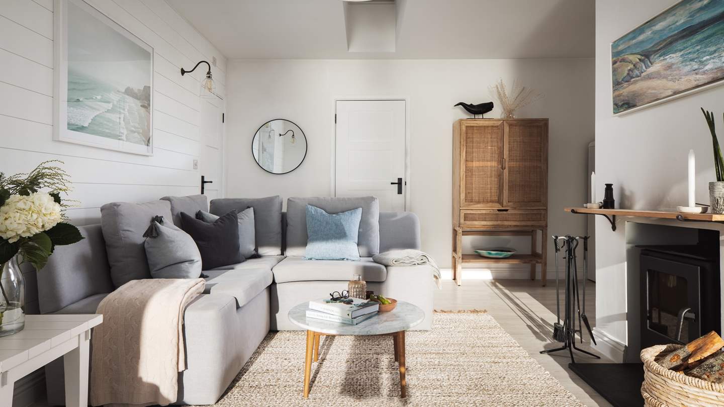 The large L-shaped sofa is just made for sprawling out on whilst gazing out to sea