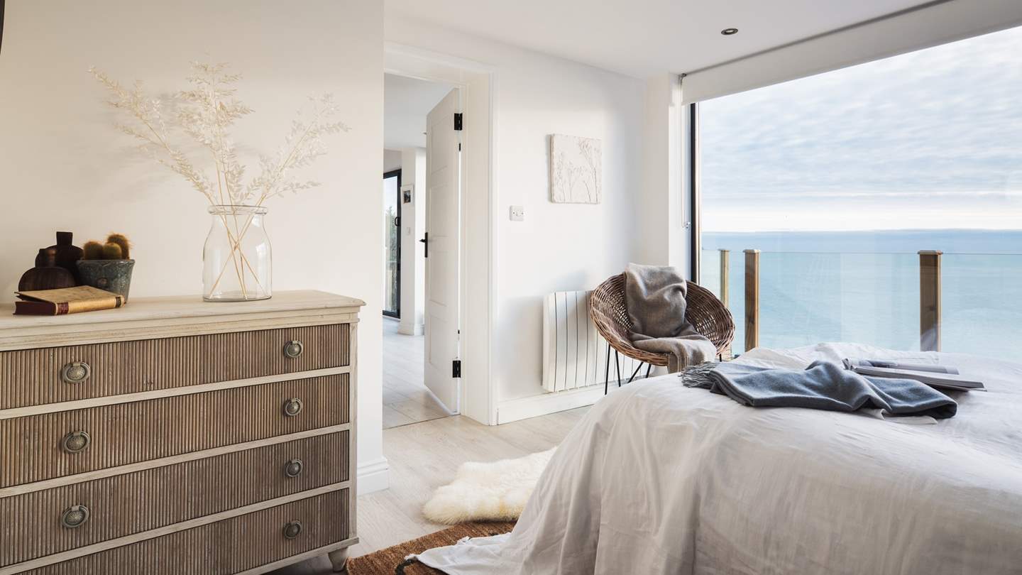 With floor-to-ceiling glass windows and a door leading directly out on to the deck, you've a cinematic view of the ocean from morning to night