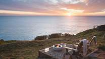 From the lower deck, steps lead down into the cliff top garden where the fire pit is a must for  watching the stars twinkle above 