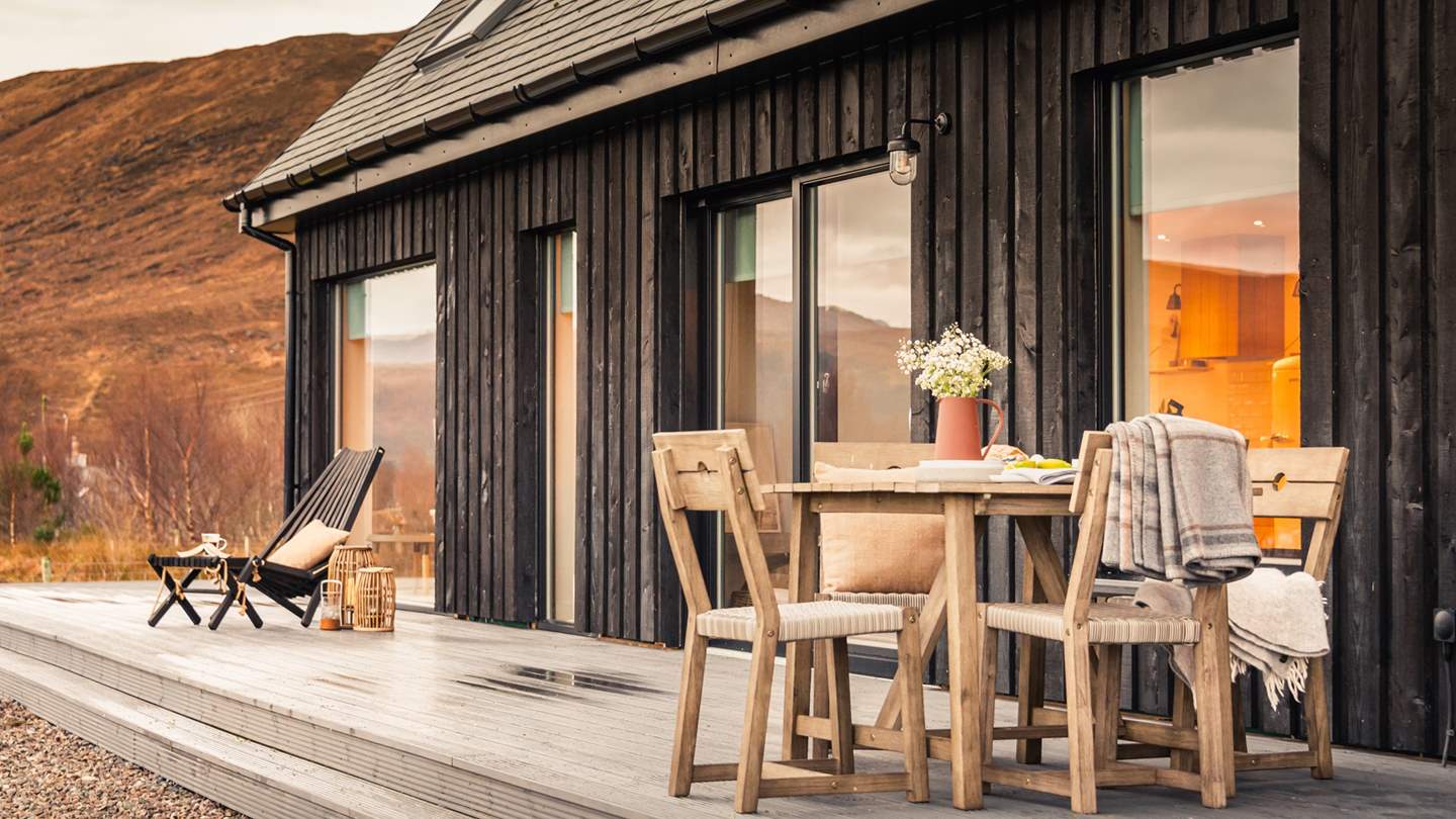 To the front of Aulinn is an open veranda with a table and chairs for alfresco dining