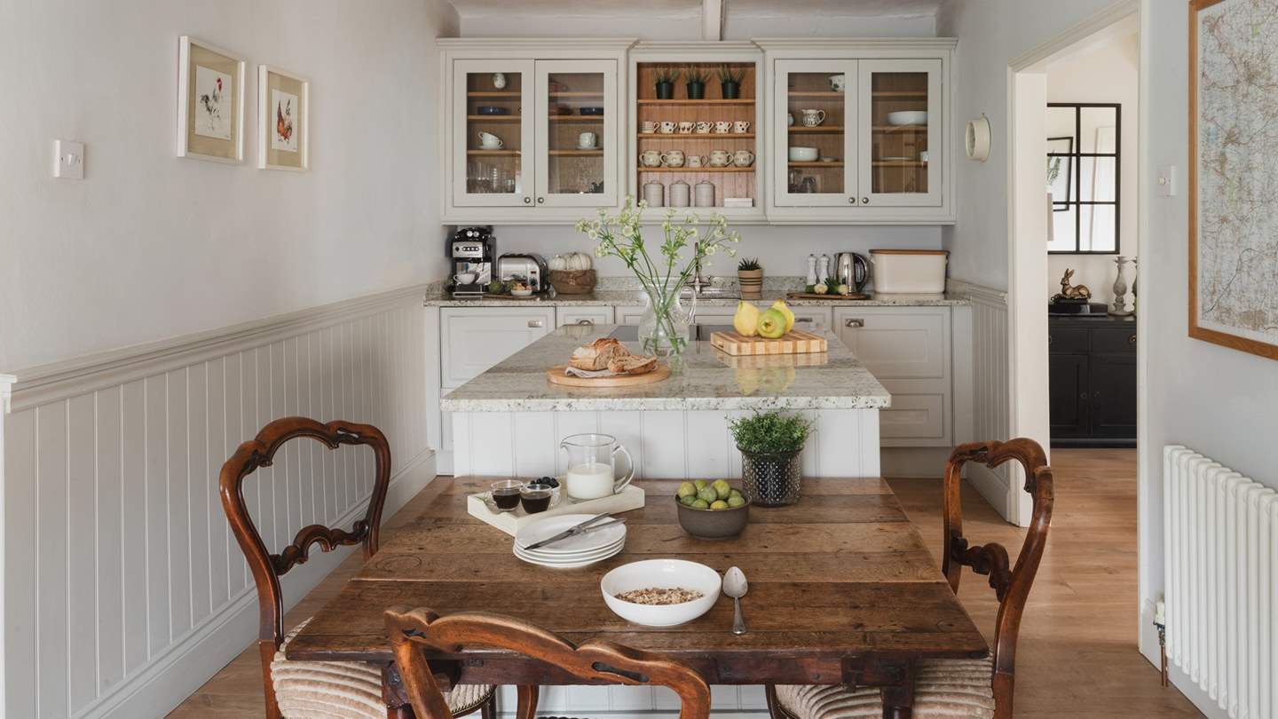 The contemporary country kitchen with granite tops boasts a double oven, induction hob and has a large island for prepping food and everything else you might need to rustle up meals for your loved ones