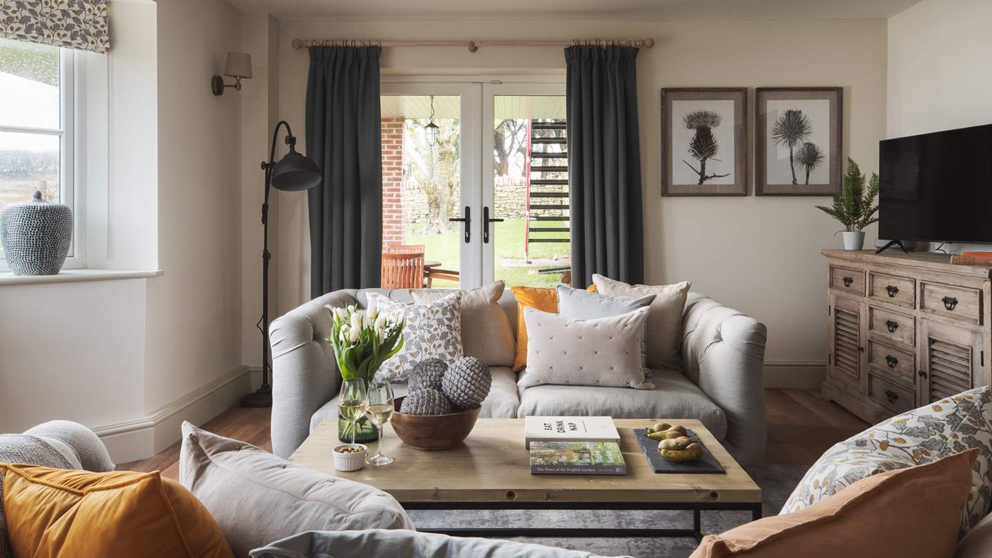 Doors lead out from the sitting room to the covered patio area