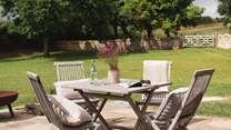 Step out to the patio area with a breakfast table set for four, perfect for alfresco brunches
