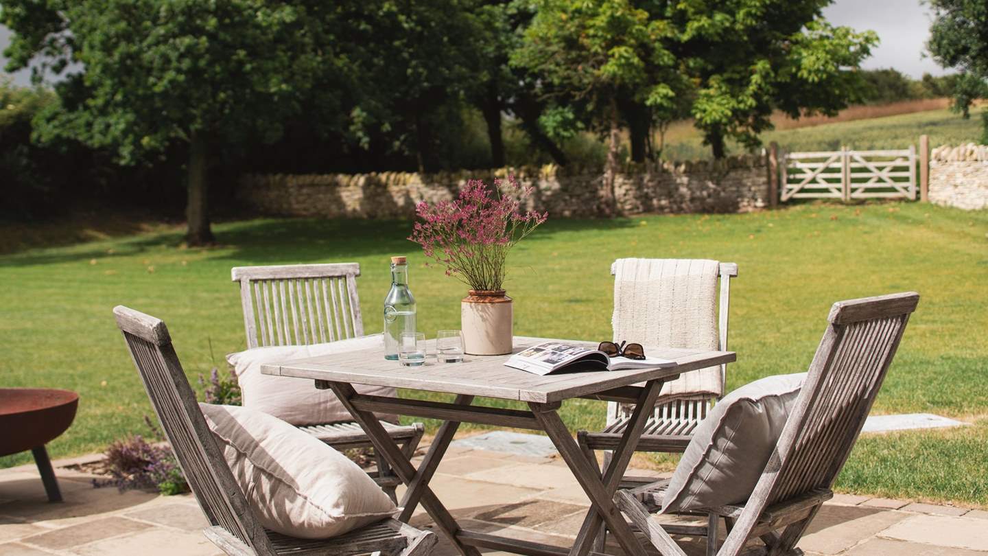 Step out to the patio area with a breakfast table set for four, perfect for alfresco brunches