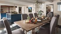 Lying next to the gorgeous kitchen is the majestic dining table that extends to seat eight people