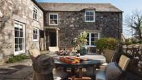 The pretty cottage garden comes complete with a courtyard that has a dining table and chairs plus a barbeque 