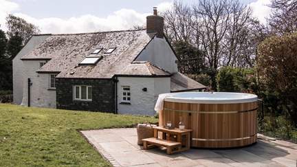 The bubbling hot tub provides a serene spot to sit back and unwind in the quiet of the countryside...