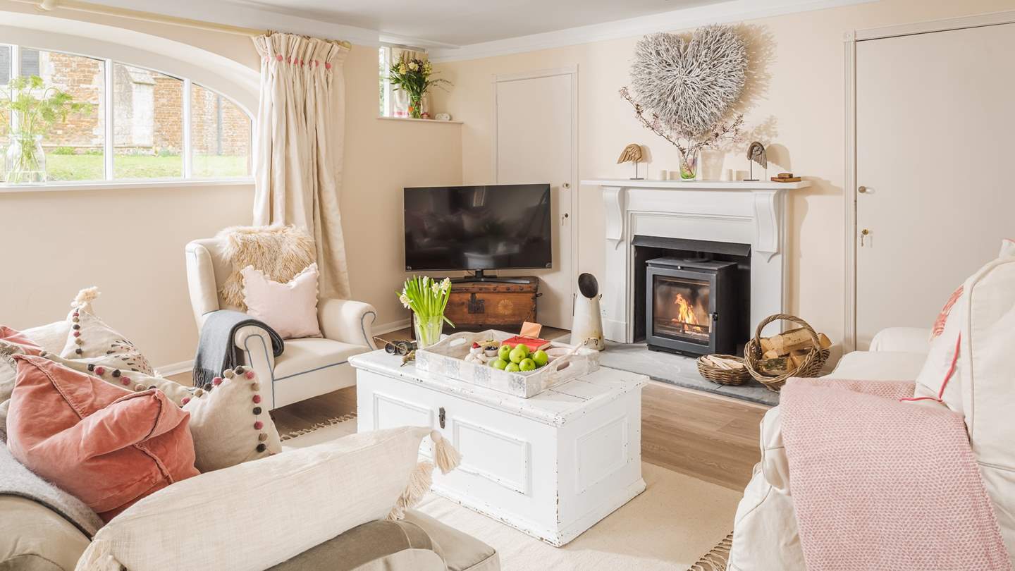 Oh-so-cosy, the sitting room with flickering wood burner is the perfect spot to unwind