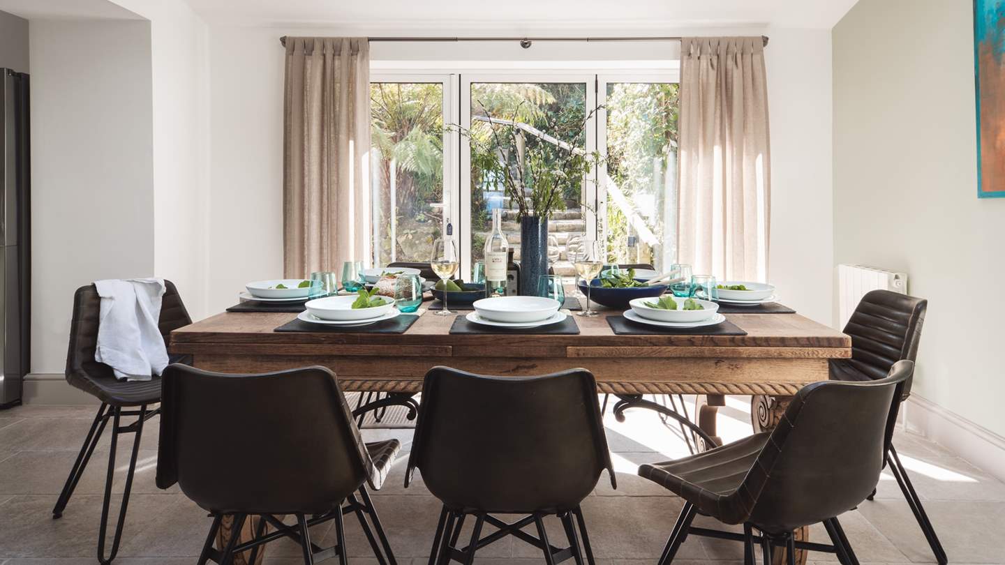 The spacious dining area has glass doors leading out into the back garden