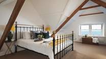 The master bedroom lies on the second floor, with stunning vaulted ceiling and dual aspect windows