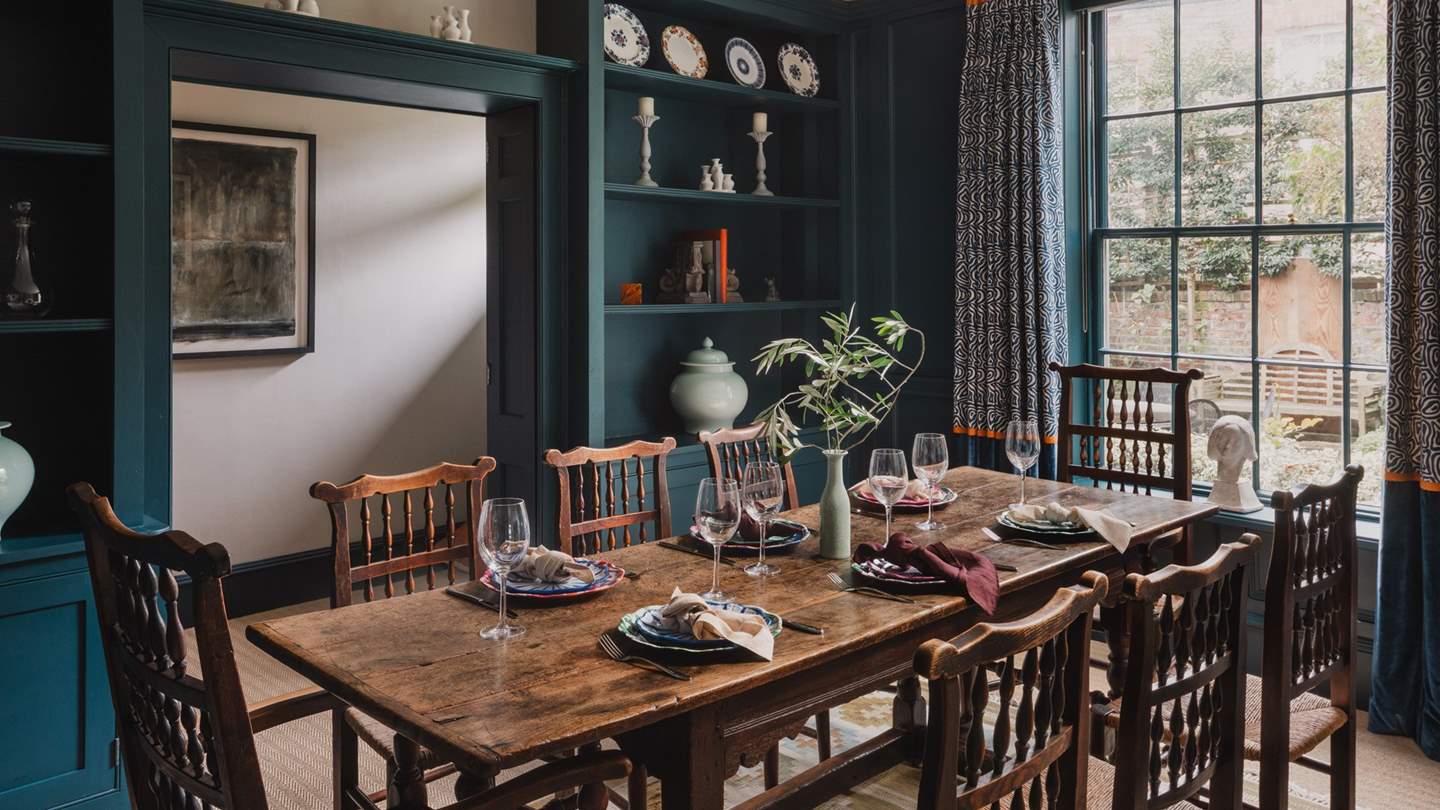 Sweet alcoves are adorned with complementing unique antique pieces in the formal dining room
