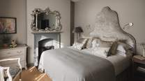 In serene greys, the second bedroom with a super-king is equally romantic
