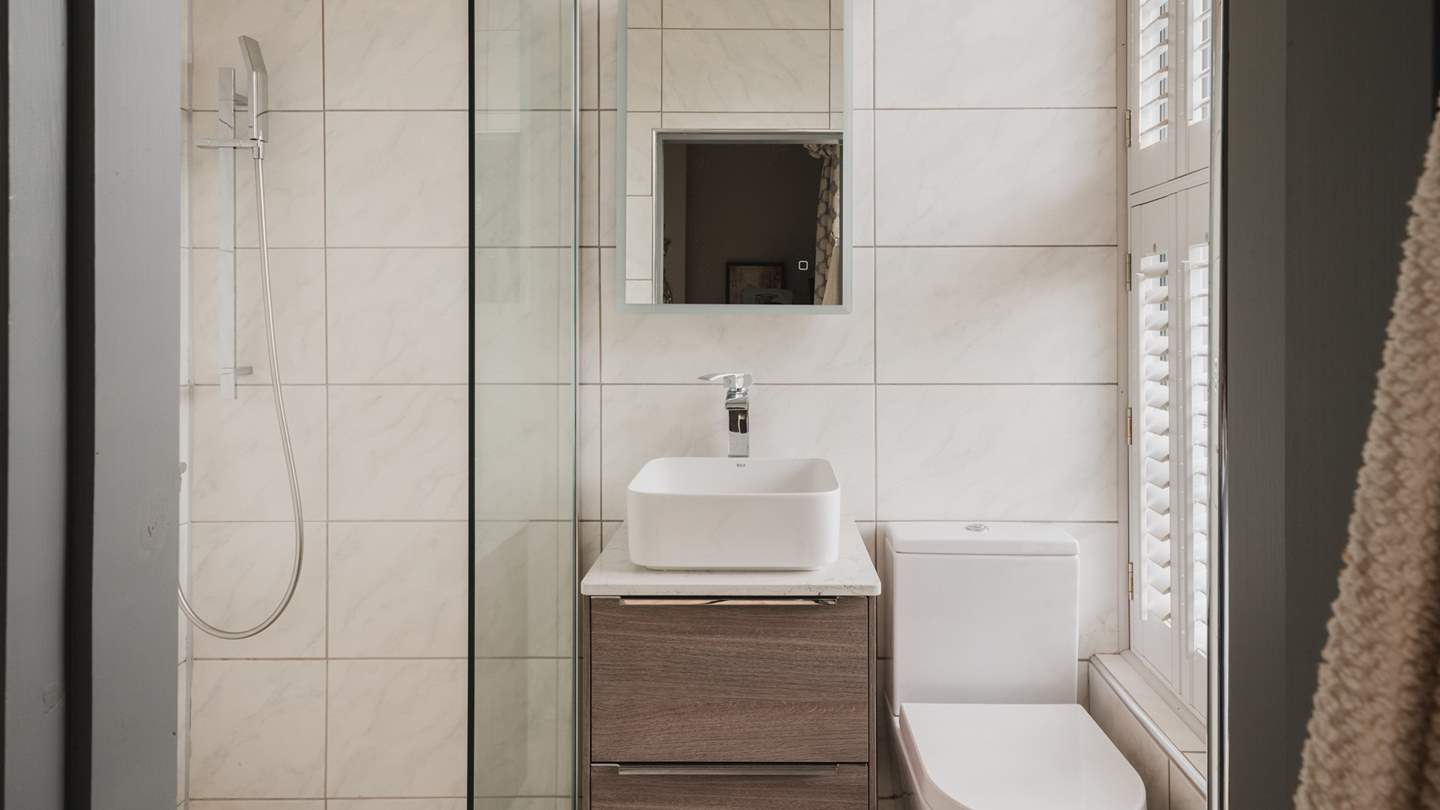 Adjacent is the en suite with a walk-in shower and a heated rail