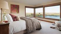The master bedroom lies on the first floor to one end and has fabulous, 180-degree views over Lamorna Valley