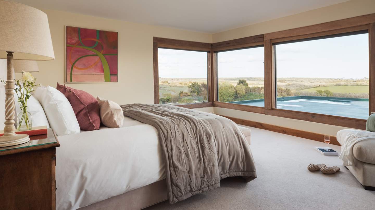 The master bedroom lies on the first floor to one end and has fabulous, 180-degree views over Lamorna Valley