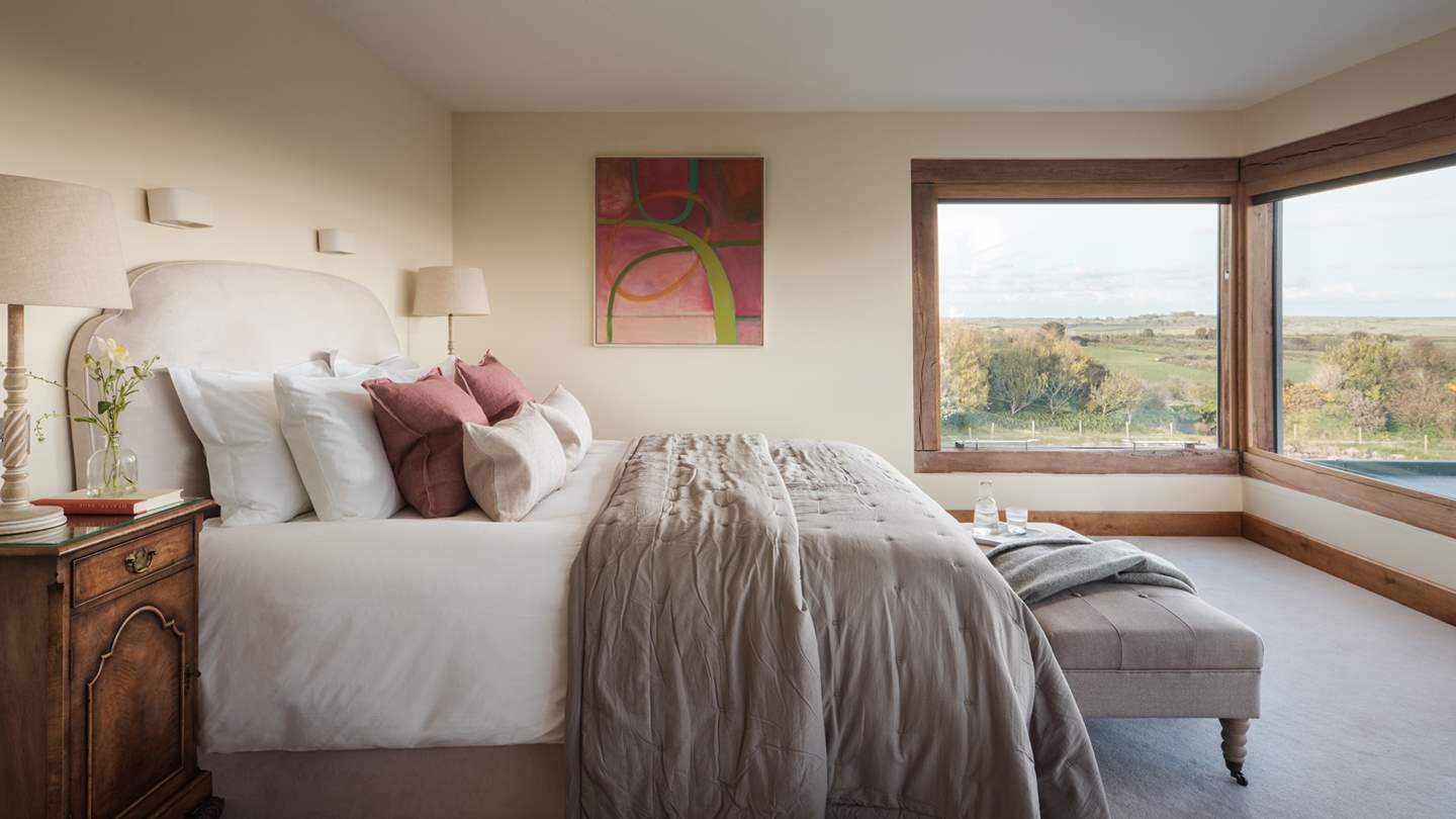 The bed is swathed in luxurious linens