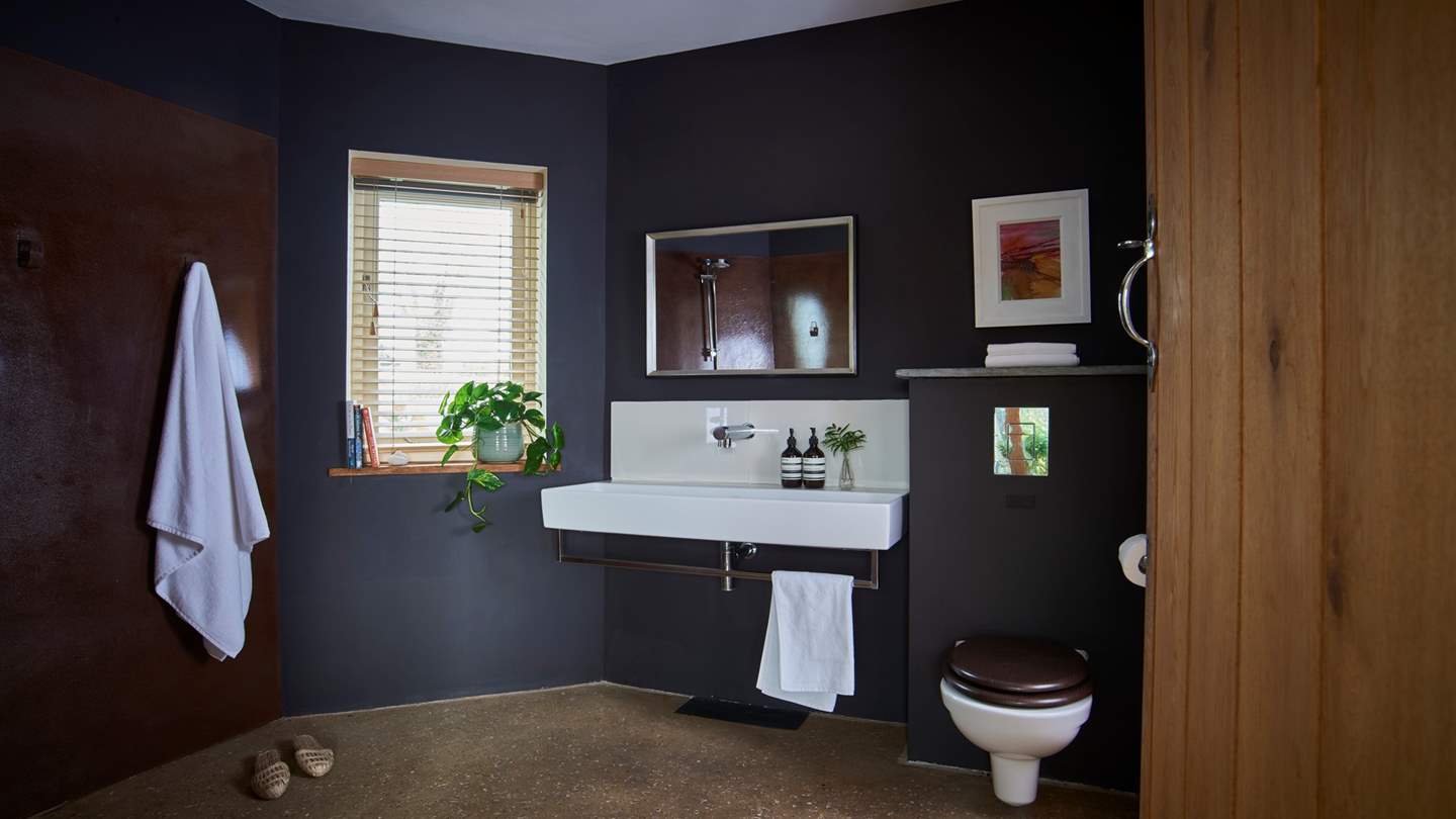 The downstairs shower room for rinsing off and storing wetsuits

