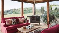 With stunning views, plentiful living space and a cosy wood burning stove 