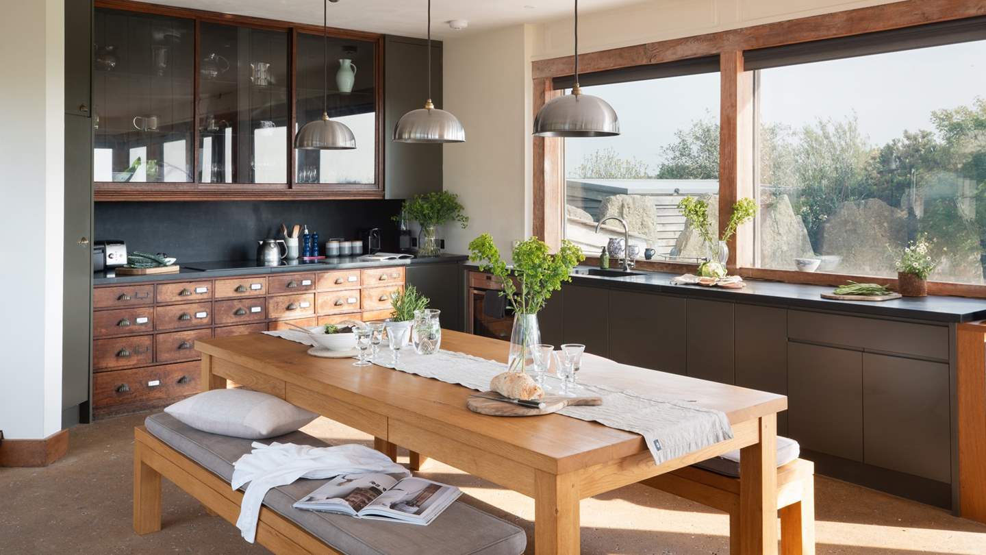 The slate-topped kitchen itself boasts a stunning reclaimed Victorian ironmongers cabinet