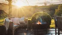Curl up by the fire pit as the sun sets and the stars rise above