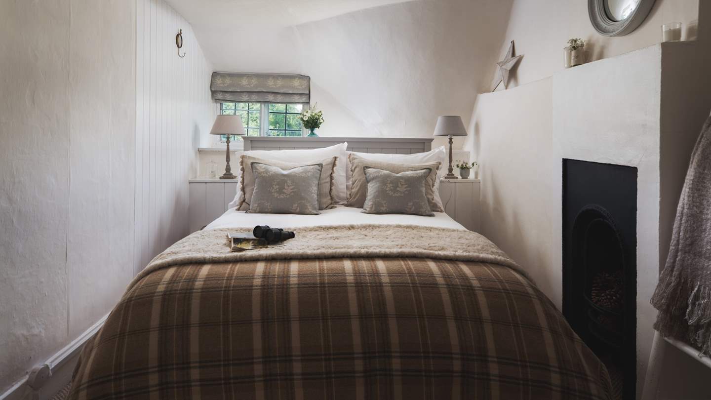 The blissful second bedroom with original feature fireplace