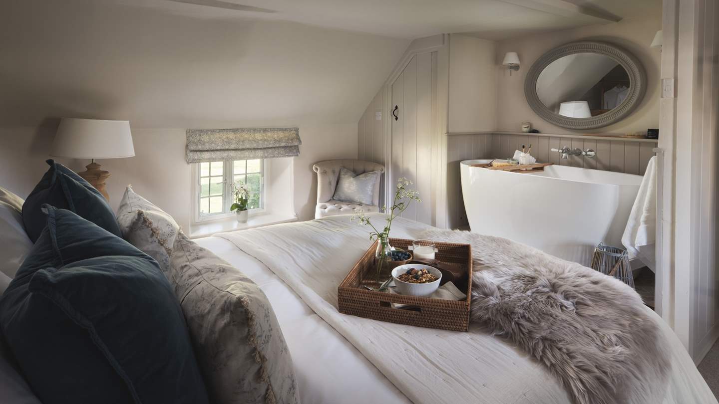 The oh-so-romantic master bedroom is simply a delight, with decadent bath tub...