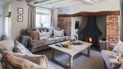 The idyllic sitting room, with flickering wood burner, is an escape to retreat to at the end of the day