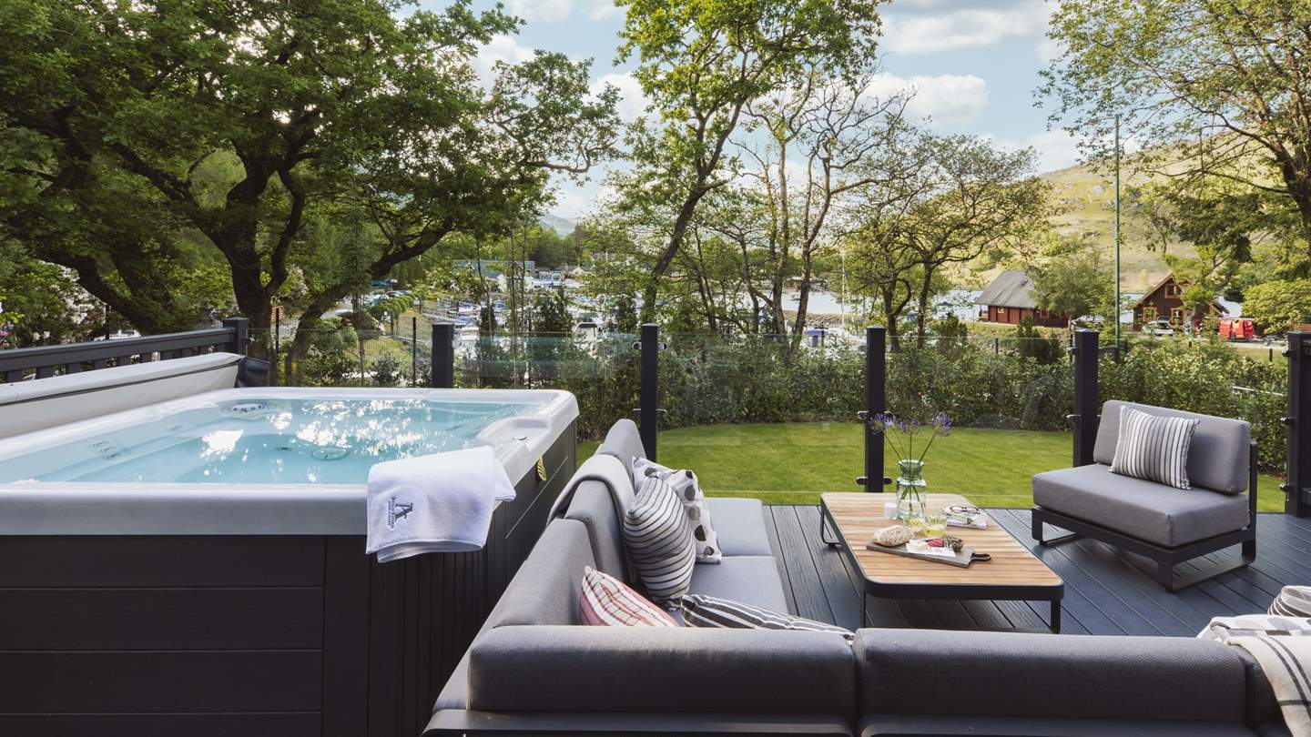 With a bubbling hot tub and plenty of space to relax, this is a lovely spot overlooking the marina