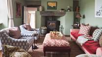 The stunning sitting room with cosy wood burner is just a delight to retire to at the end of a day out exploring