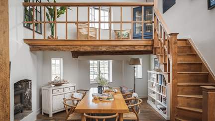 The gorgeous wooden stairway, plus spot the wood burner to make mealtimes extra cosy
