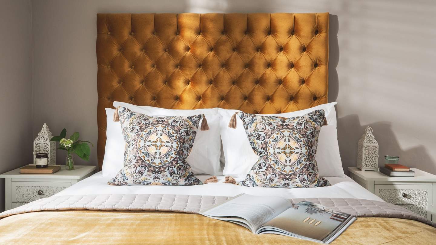 The stunning first bedroom, with king size bed and dual aspect windows